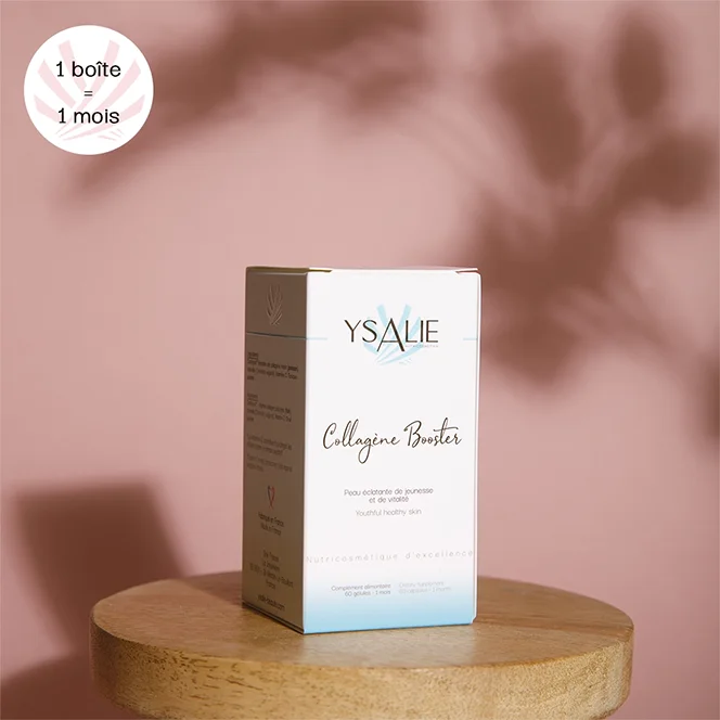 Boîte du Complément Alimentaire Collagène Booster pour les rides profondes posé sur un plateau en bois le tout sur un fond rose